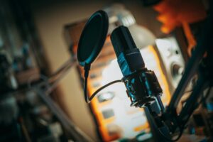 Pod Save America Hosts Are Expanding Into Traditional Television Programming Professional podcast recording studio with microphones and equipment