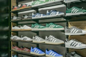 Designer Sneaker Resale Markets Are Outpacing Traditional Luxury Sales Row of premium sneakers displayed on shelves showing various colorways and styles