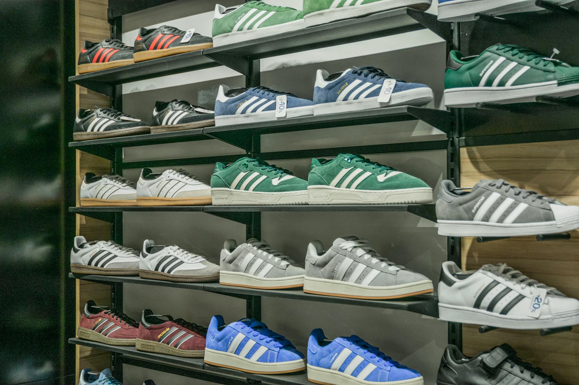 Row of premium sneakers displayed on shelves showing various colorways and styles
