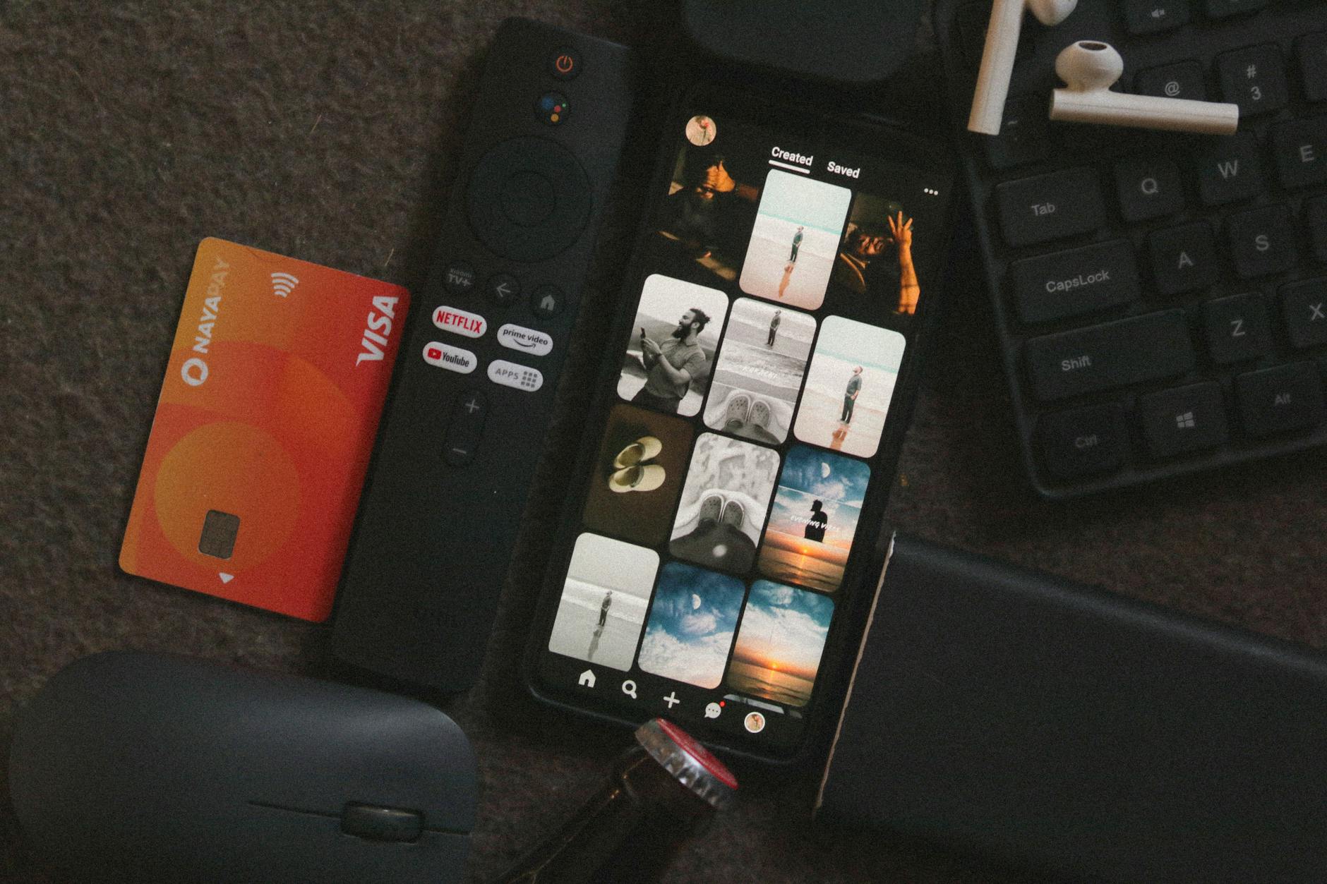 Hand holding streaming device remote control pointed at television screen
