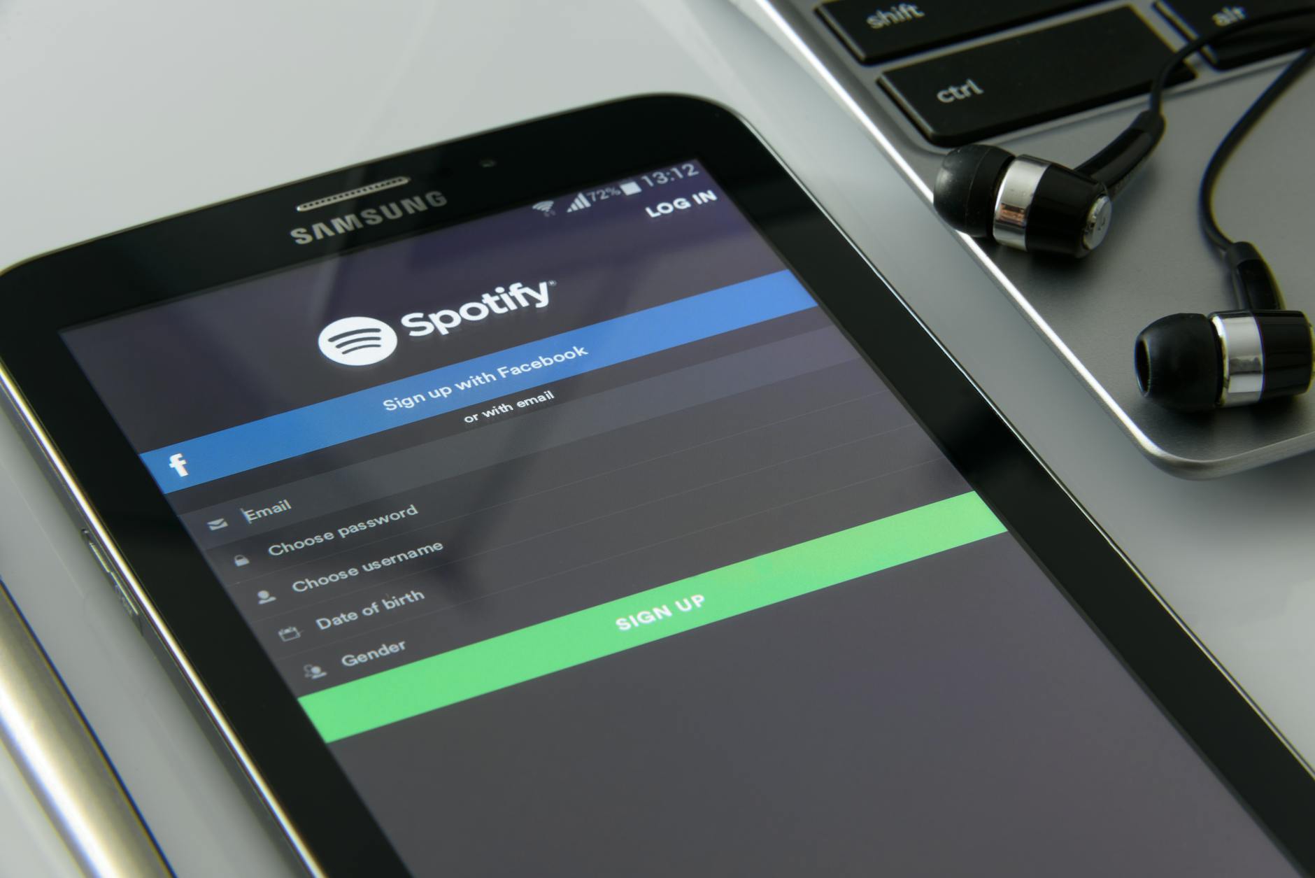 Person holding smartphone displaying a music streaming application