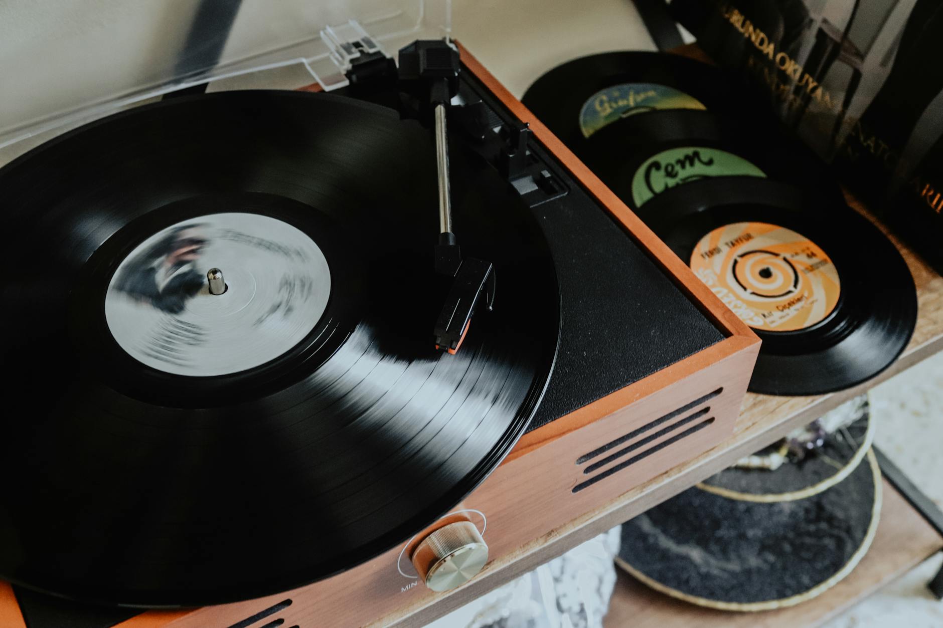 Close-up of a needle resting on a spinning vinyl record