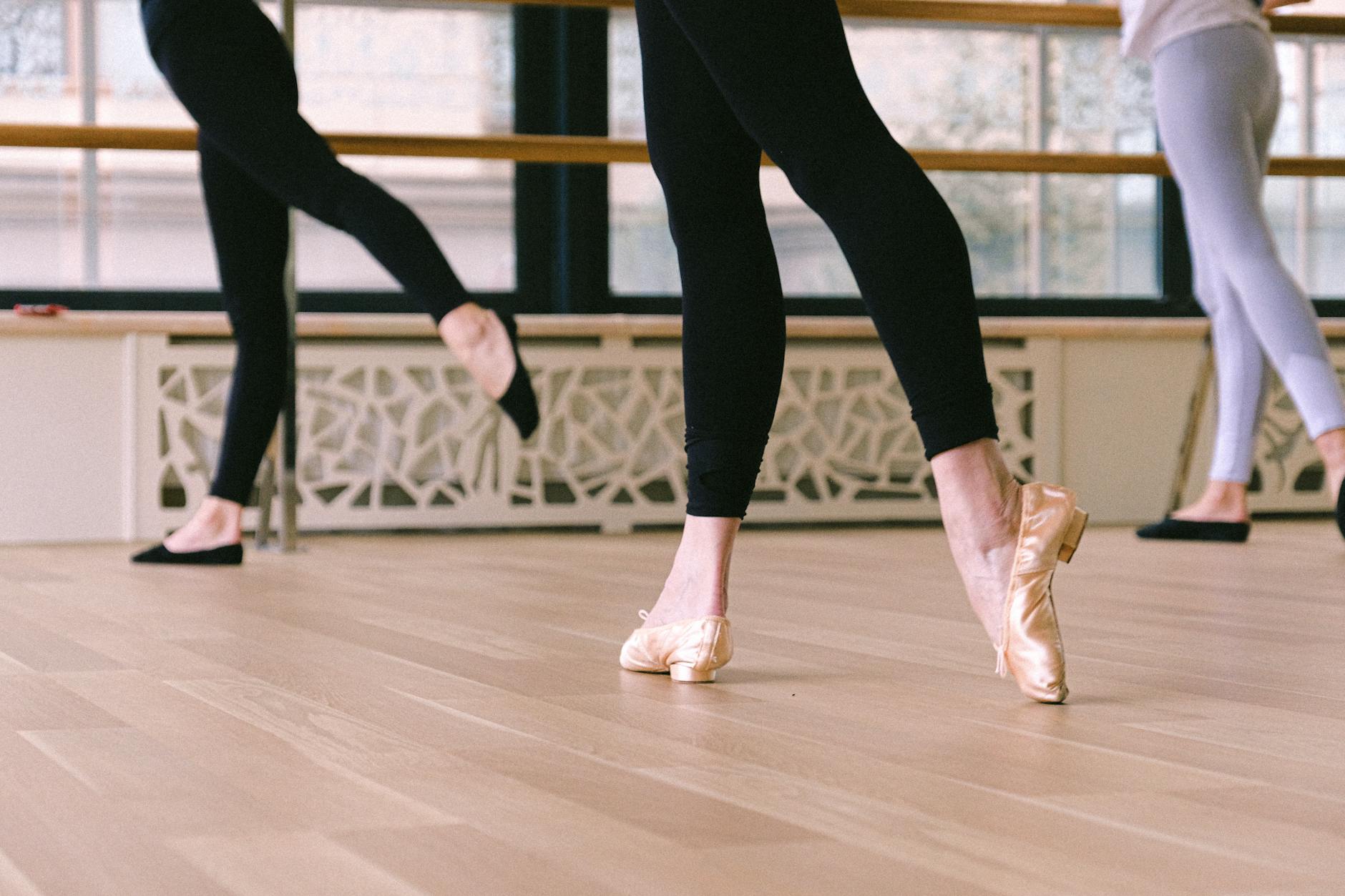 Professional dancer practicing choreography in a mirrored rehearsal studio