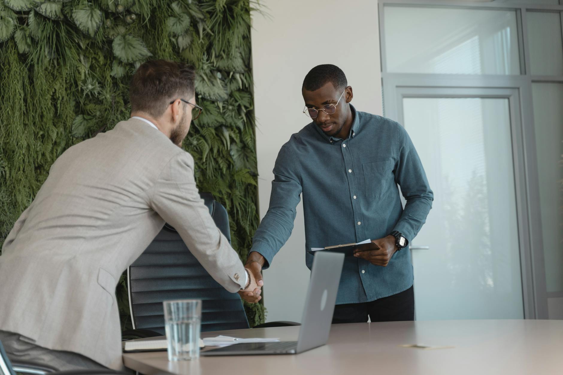 Professional handshake during business meeting representing investment partnership