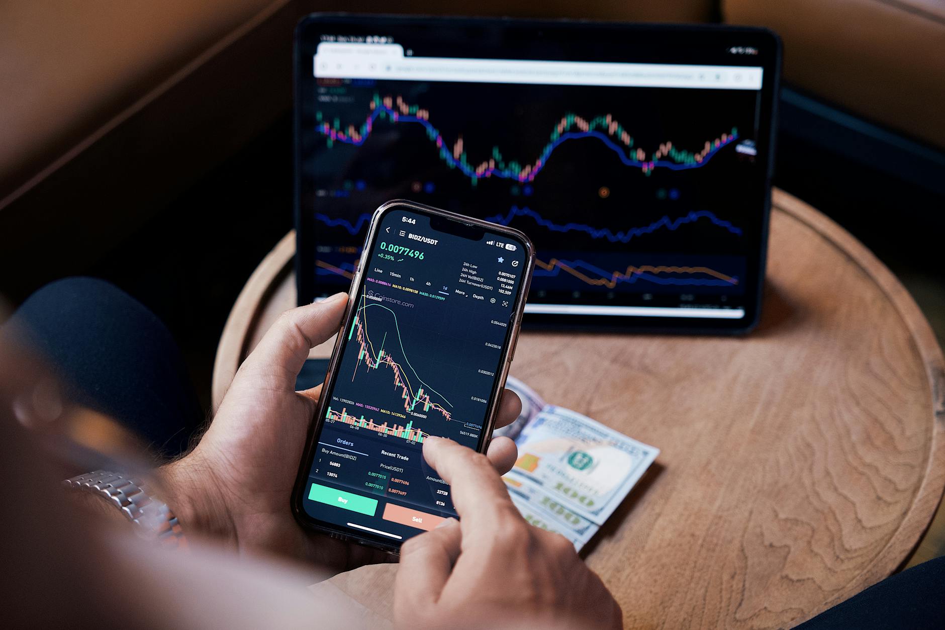 Smartphone screen showing trading application with price charts and market data