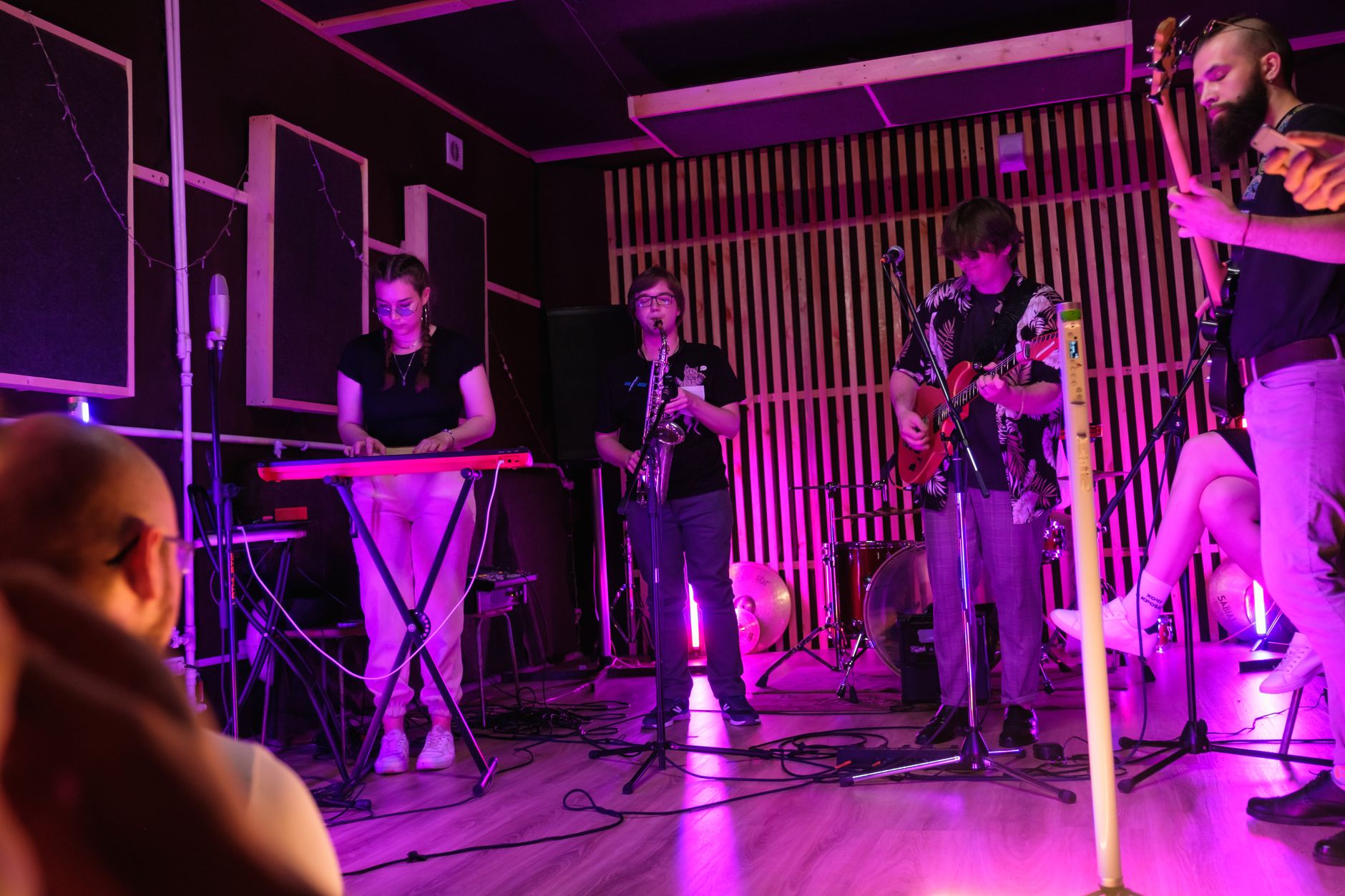 Small audience watching a live music performance in an intimate venue