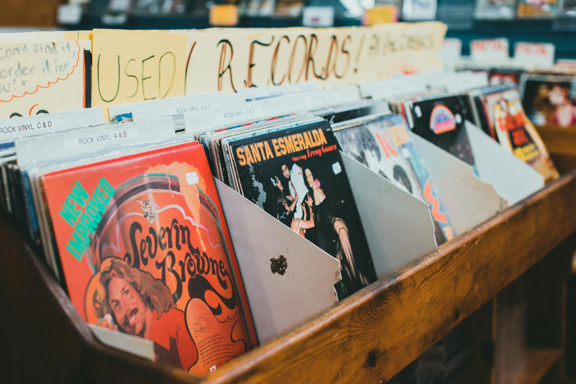 A curated collection of vinyl album covers stacked on a shelf