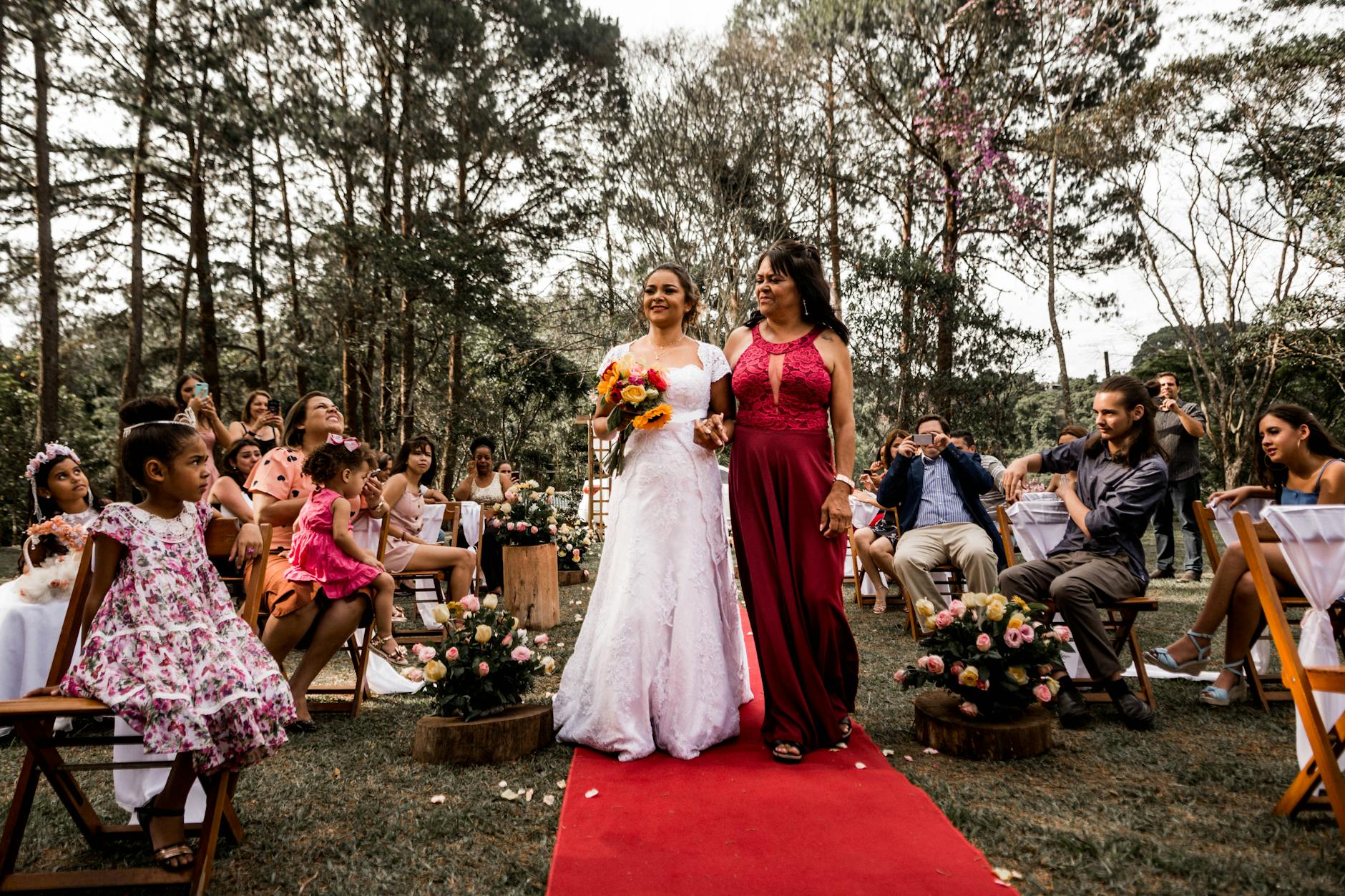 Guests arriving at a formal red carpet event dressed in elegant evening wear