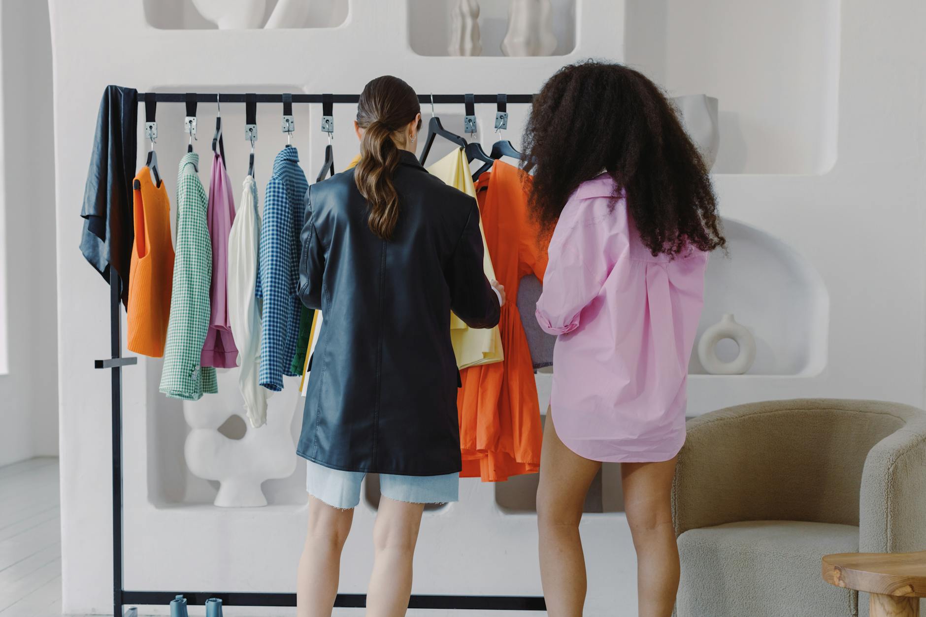 Curated designer garments hanging on a rack in a fashion showroom