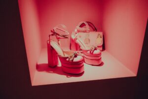 Bottega Veneta’s Rubber Clogs Are Splitting Fashion Critics High-end shoes displayed on a minimalist retail shelf, representing luxury footwear presentation