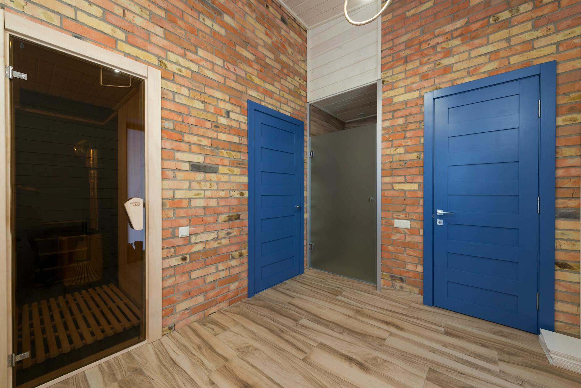Warm wooden sauna interior with benches and soft lighting, designed for communal use