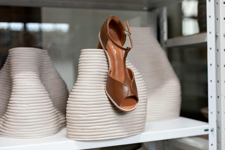 Close-up of a minimalist leather flat sandal on a clean surface