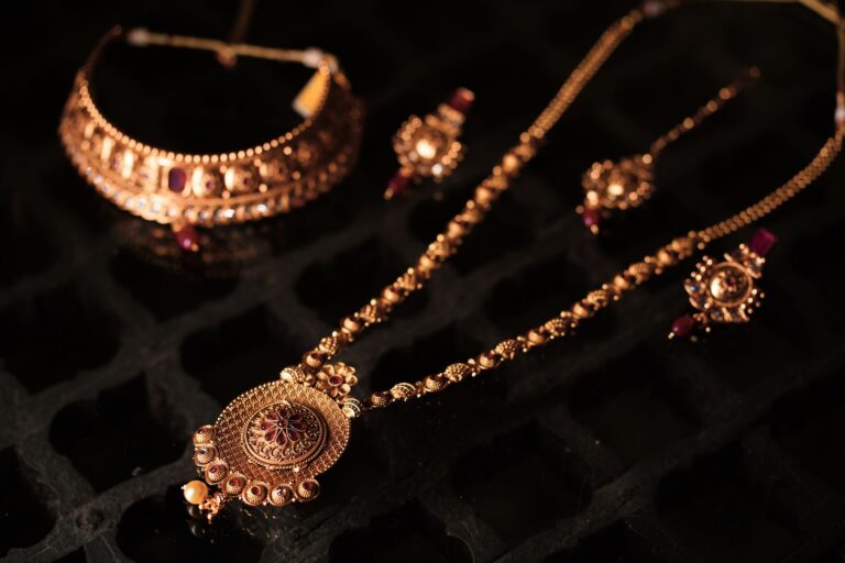 Versace’s Medusa Motif Is Creeping Back Into Celebrity Wardrobes Close-up of ornate gold fashion jewelry with bold decorative detail