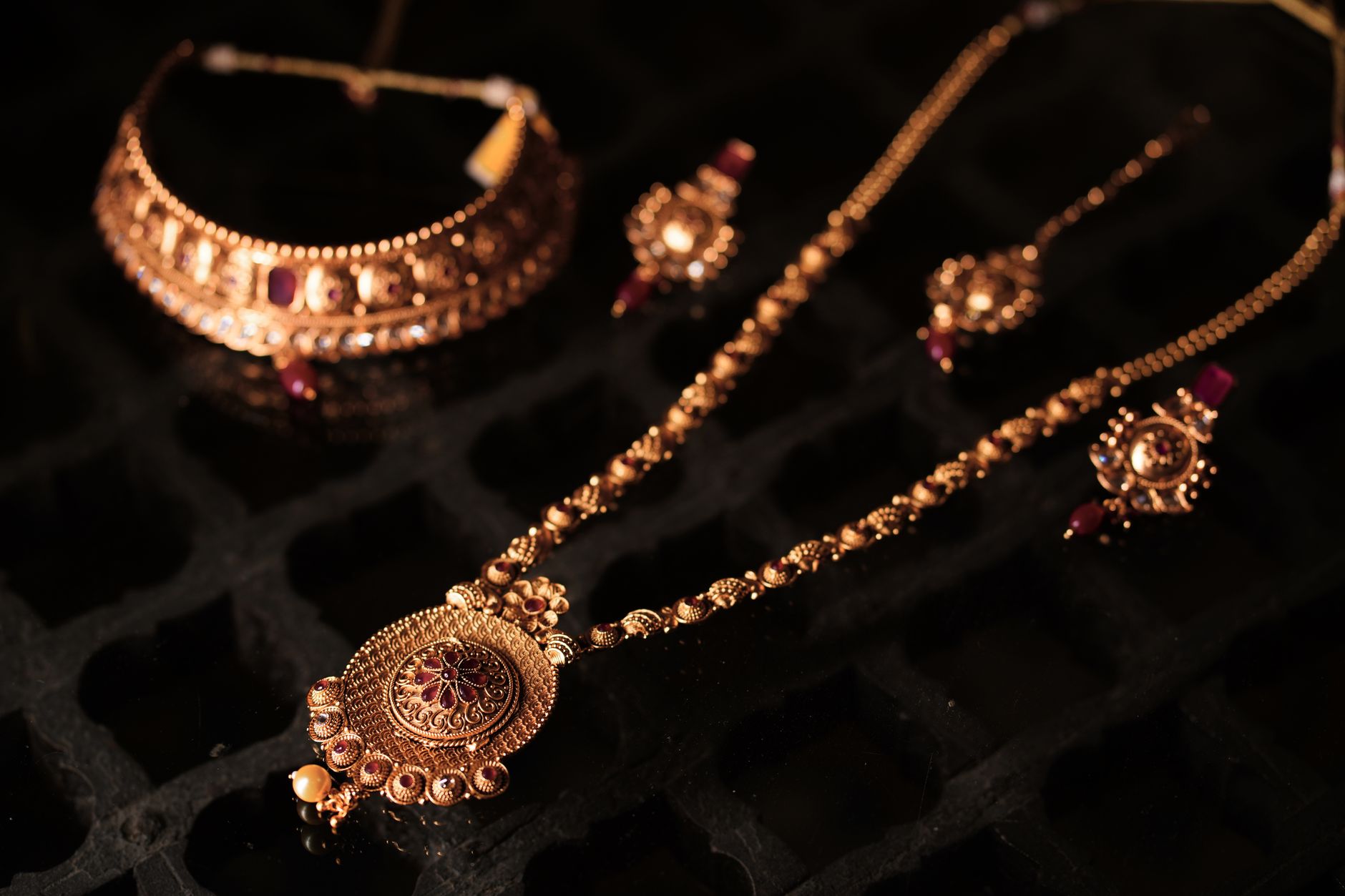 Close-up of ornate gold fashion jewelry with bold decorative detail