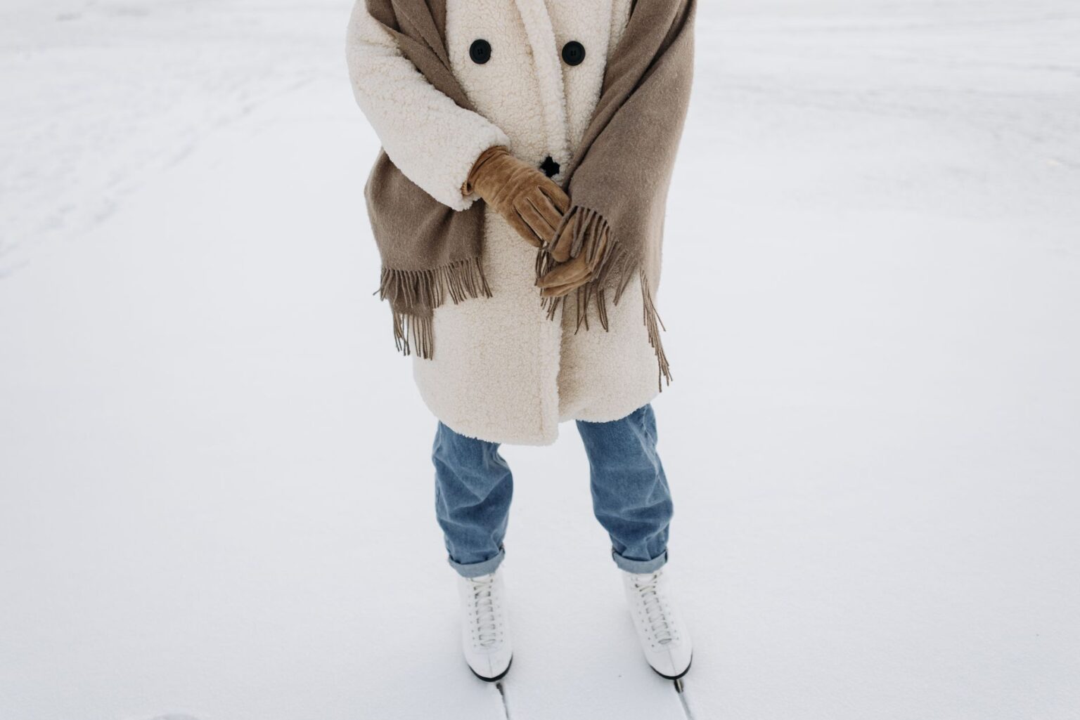 Acne Studios’ Scarf Coat Is Becoming Winter’s Unlikely Status Piece A person wearing an oversized wool wrap coat on a city street in winter