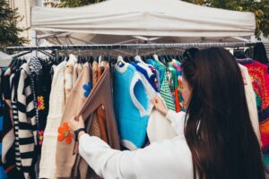 Helmut Lang’s Archive Pieces Are Flooding Vintage Markets Again Vintage clothing hanging on racks at a fashion market