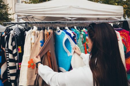 Helmut Lang’s Archive Pieces Are Flooding Vintage Markets Again Vintage clothing hanging on racks at a fashion market