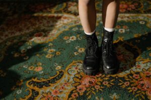 Maison Margiela’s Tabi Boot Is Crossing Over Into Everyday Dressing A pair of structured ankle boots with an unusual toe shape displayed on a clean surface