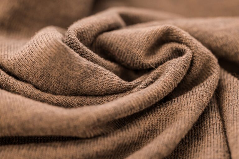 Freed from Logomania, Brunello Cucinelli Is Quietly Winning Folded cashmere sweaters in neutral tones arranged on a clean surface