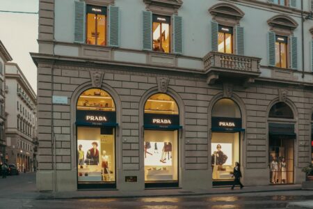 Interior of a minimalist luxury fashion boutique with sparse clothing displays