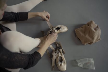Close-up of elegant ballet flat shoes on a wooden floor