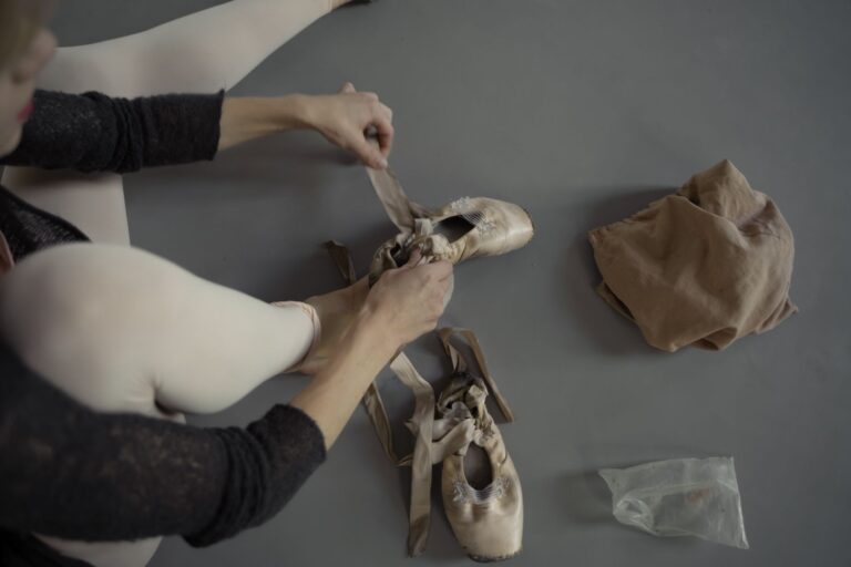 Close-up of elegant ballet flat shoes on a wooden floor