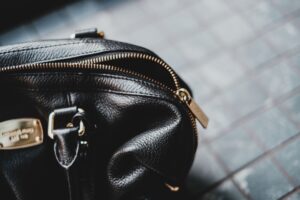 Structured woven leather handbag on a neutral background representing quiet luxury design