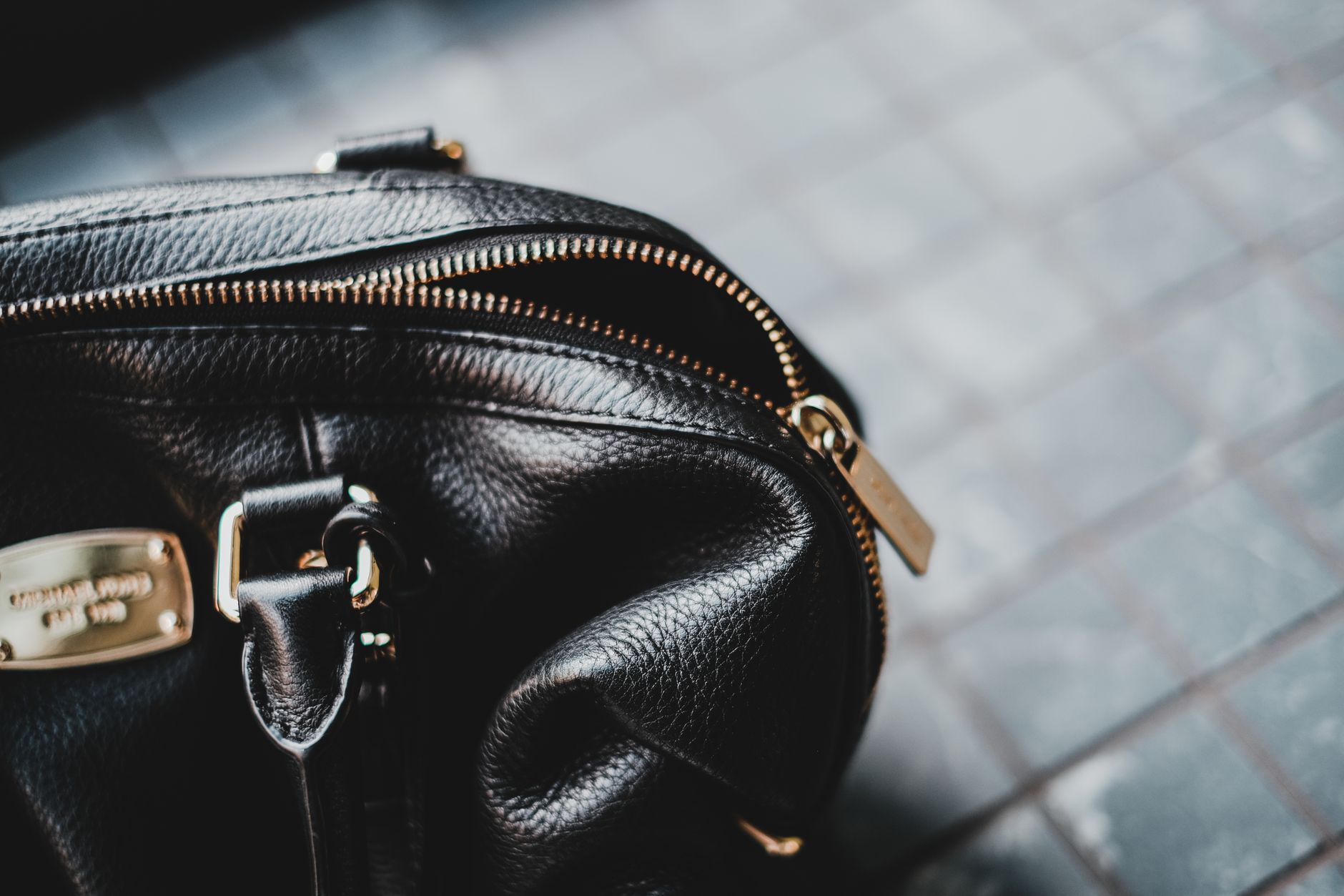 Structured woven leather handbag on a neutral background representing quiet luxury design