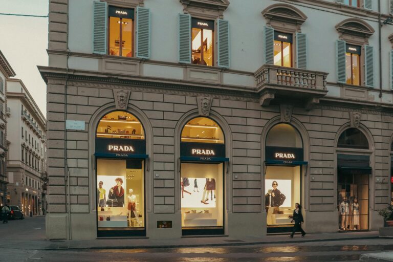 Interior of a minimalist luxury fashion boutique with sparse clothing displays