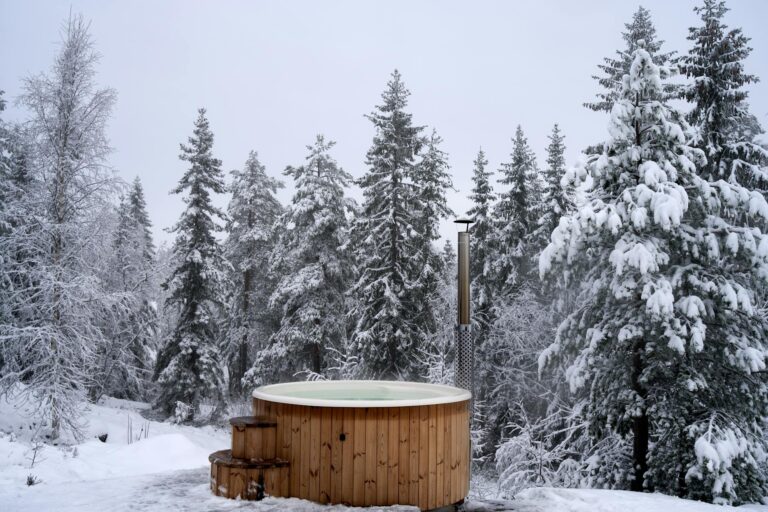 Cold Plunge Memberships Are Quietly Replacing Gym Subscriptions Person preparing to enter a cold plunge tub at a modern wellness studio
