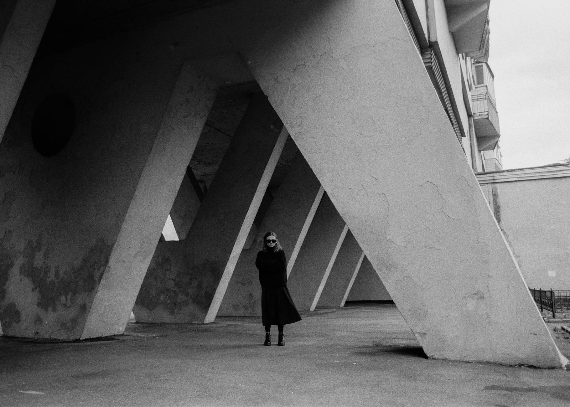 Woman wearing a structured tailored coat in neutral tones, reflecting quiet luxury dressing