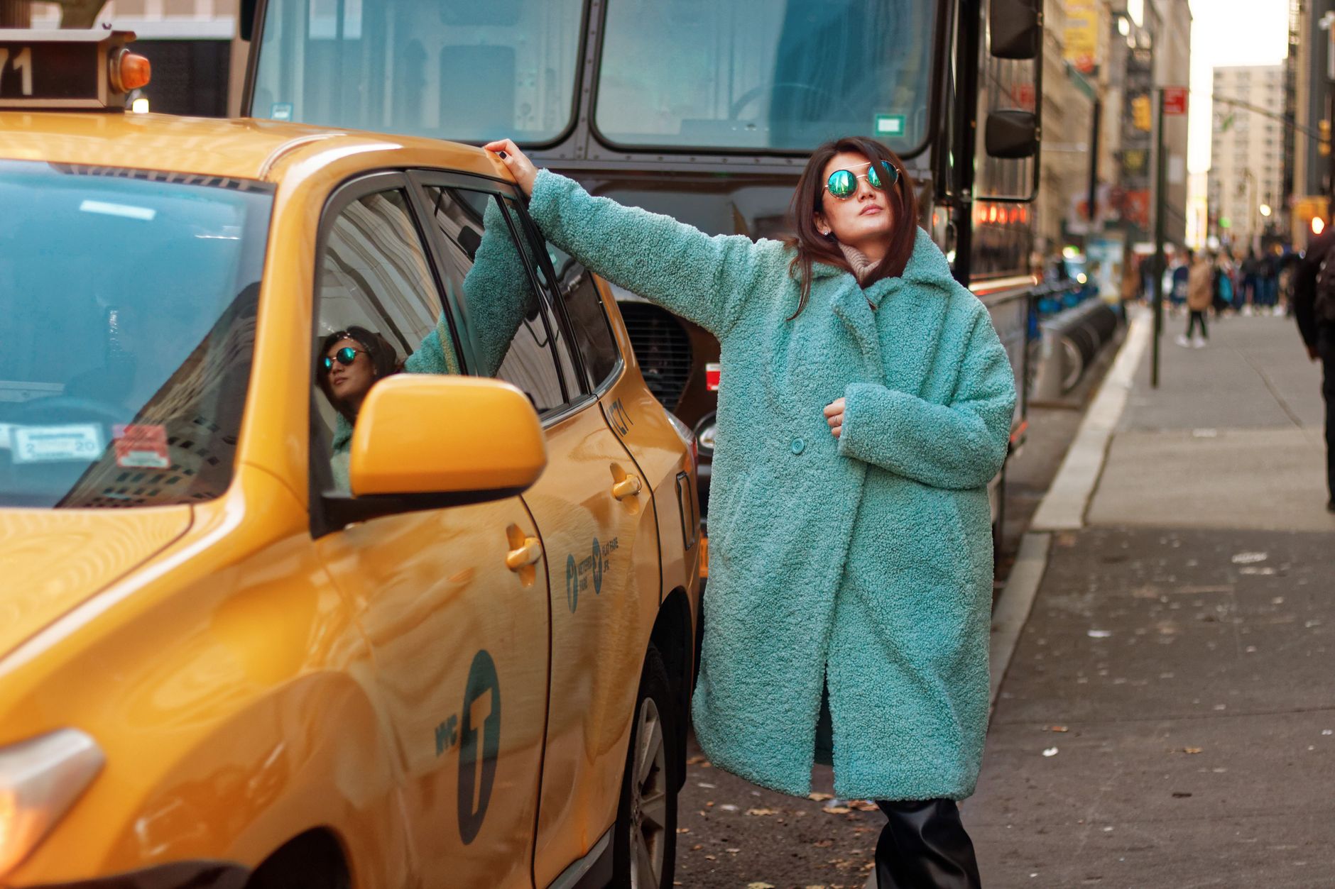 Fashion-forward pedestrians photographed on a city street during fashion week season