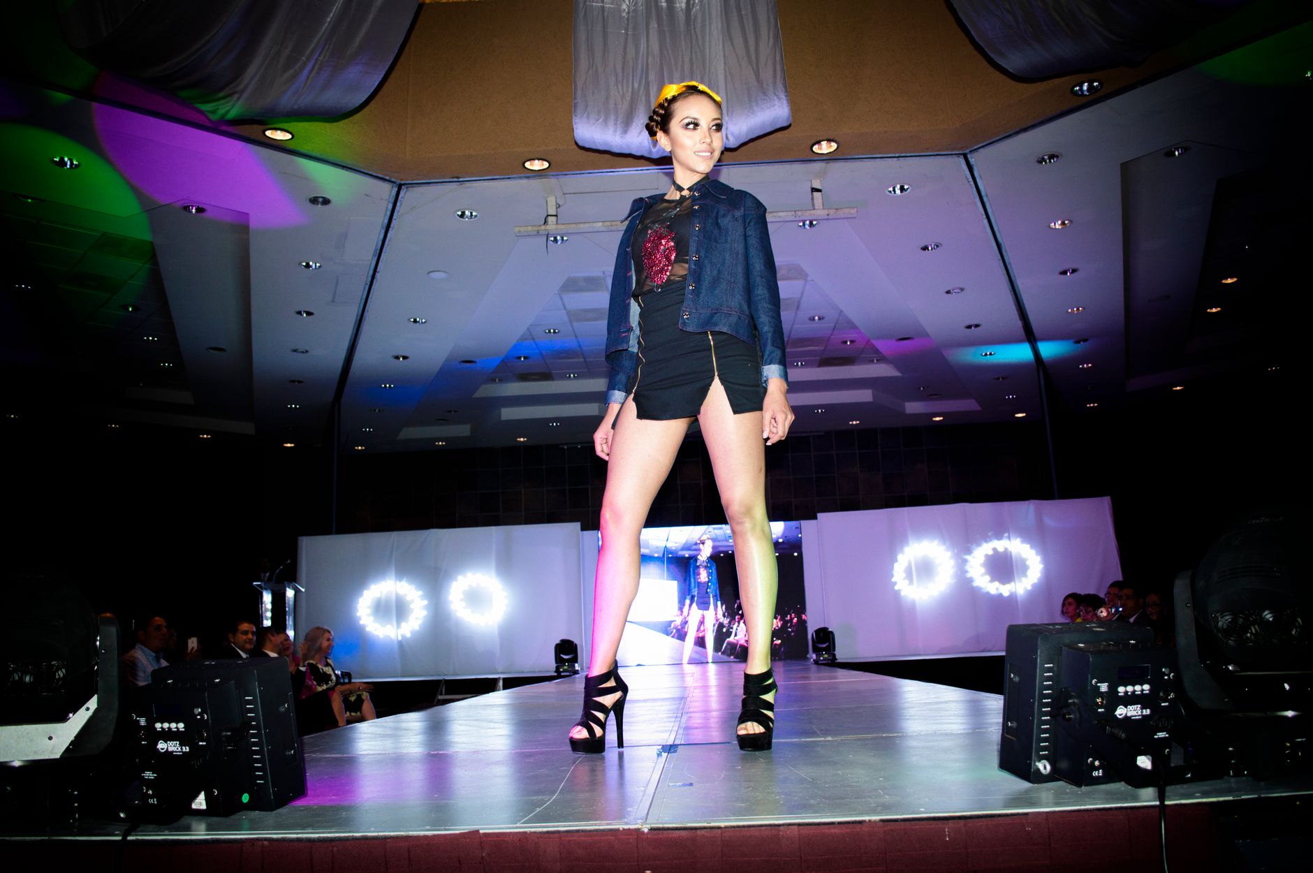 Fashion show runway with models wearing voluminous layered garments