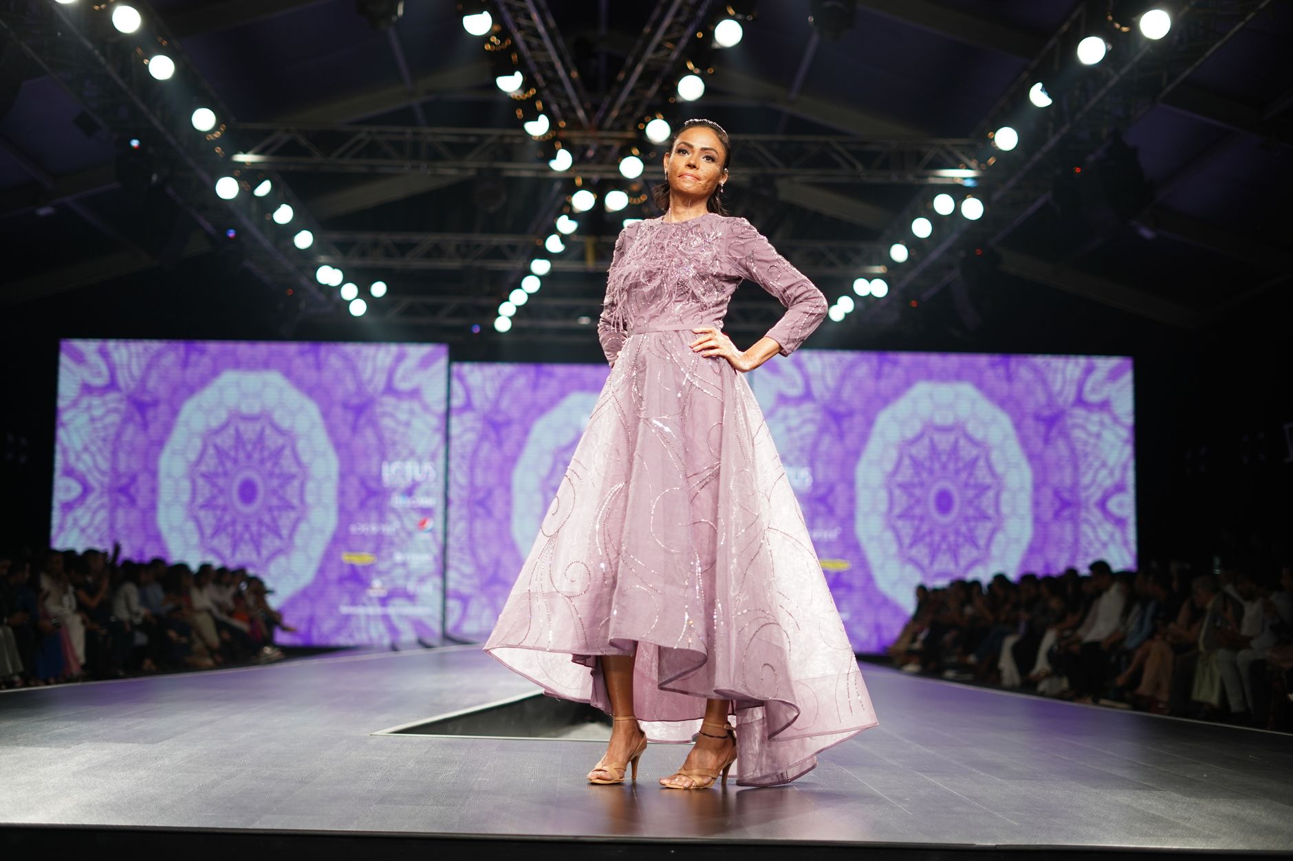 Models walking a minimalist fashion runway in structured clothing