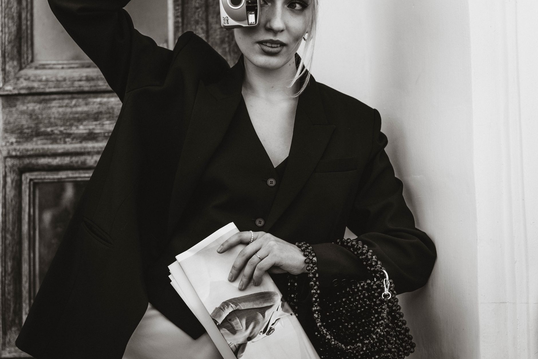 Editorial fashion photograph featuring archival clothing styled against a neutral background