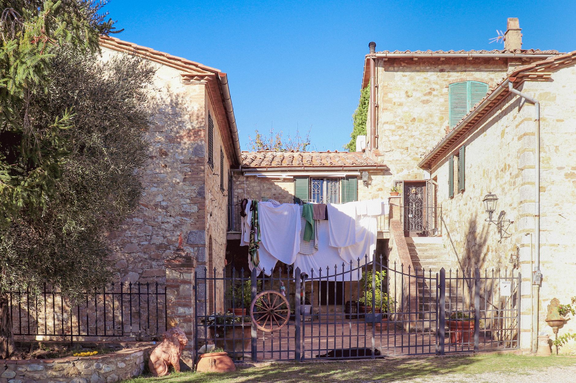 Stone courtyard of a restored medieval Italian village in soft afternoon light