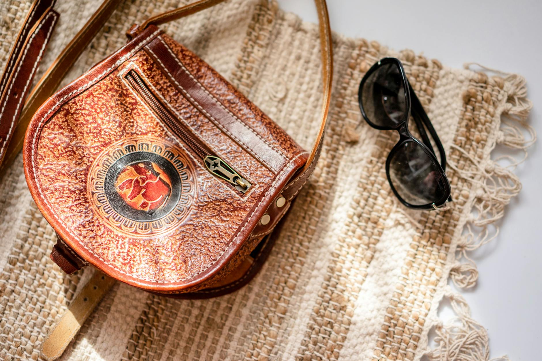 Close-up detail of a structured leather handbag with gold hardware
