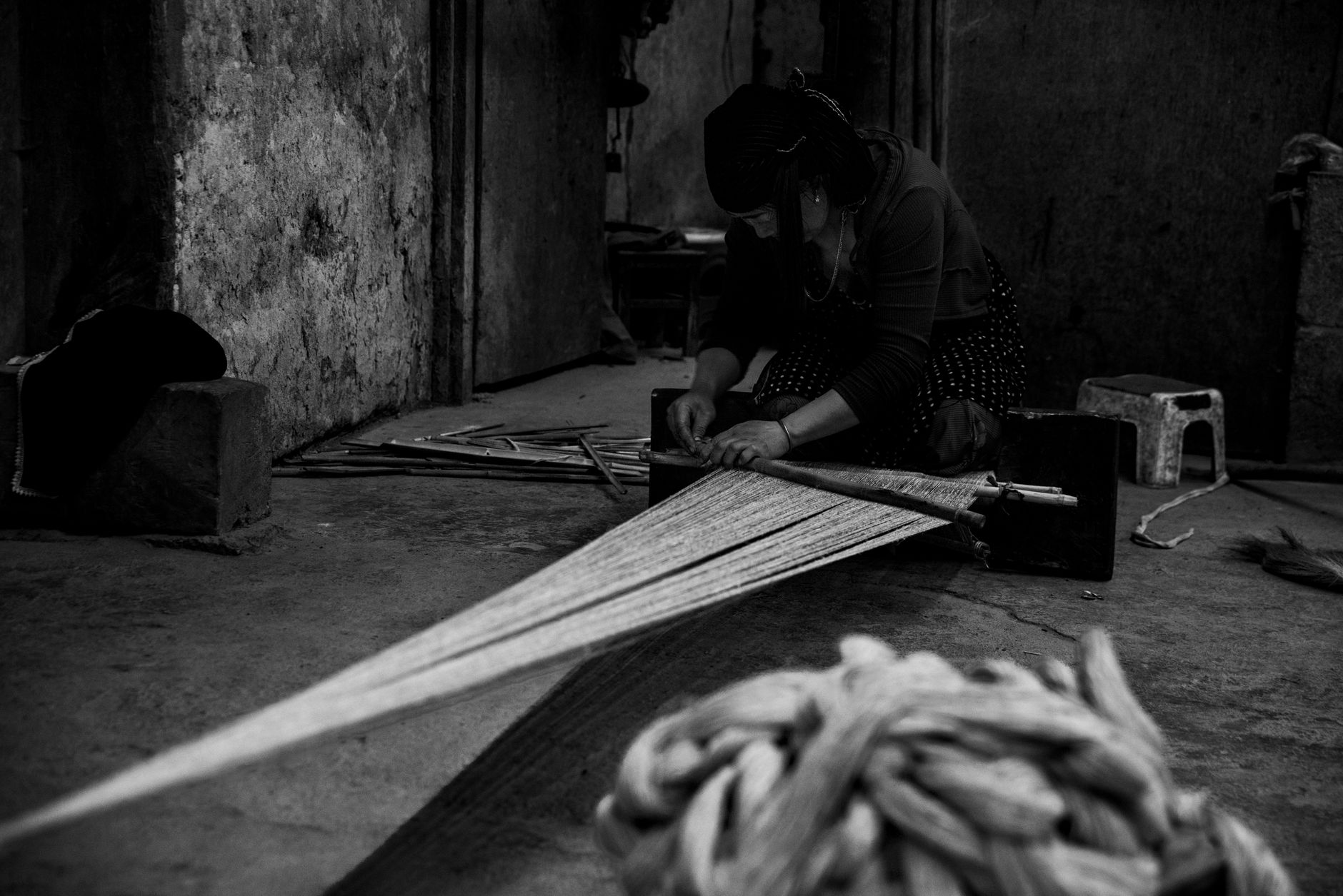 Artisan working at a traditional loom weaving fine textile fabric