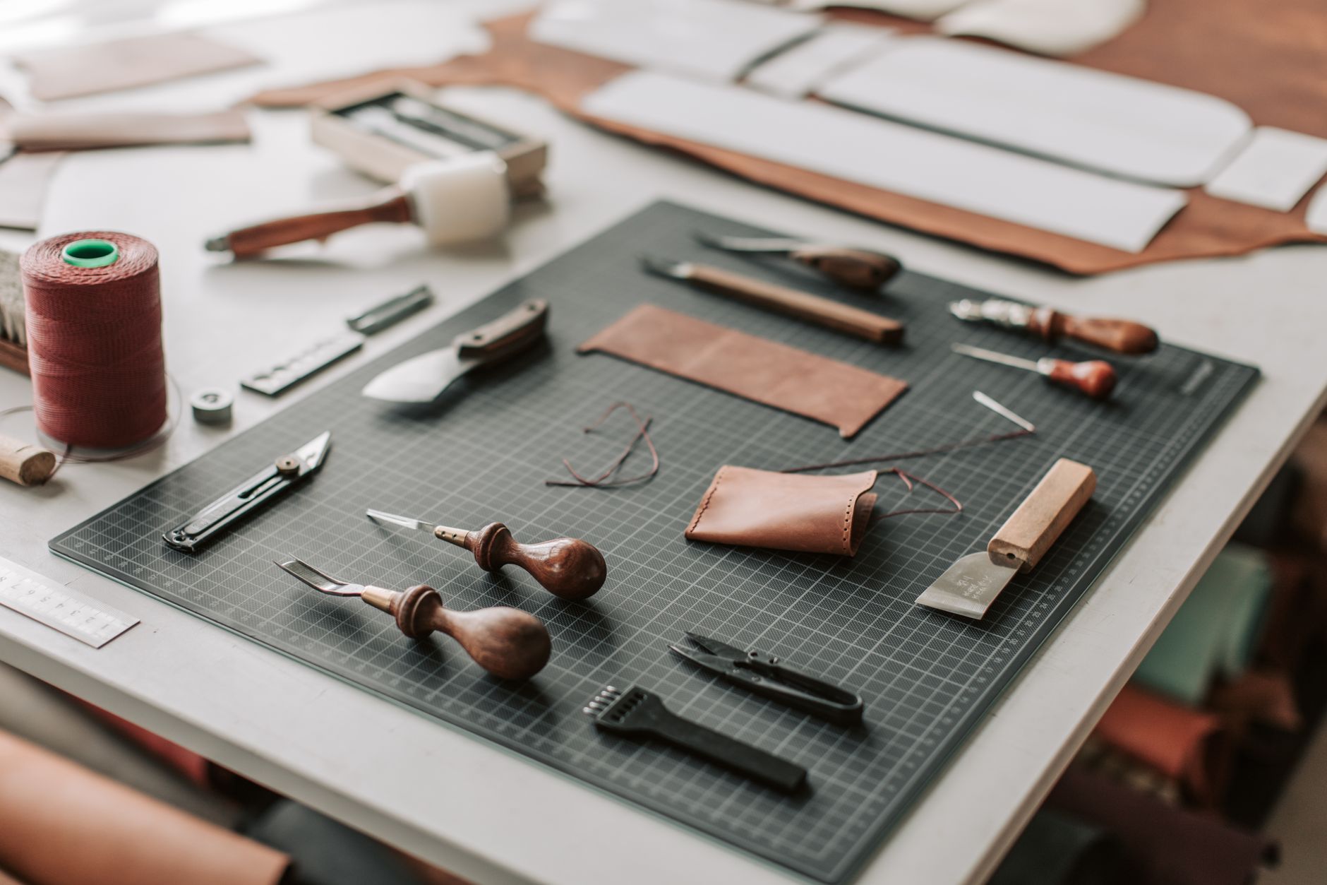 Artisan crafting leather goods in a workshop setting