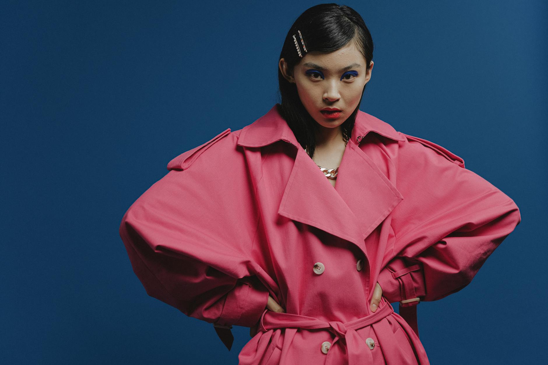 Model wearing a structured architectural coat in an editorial setting