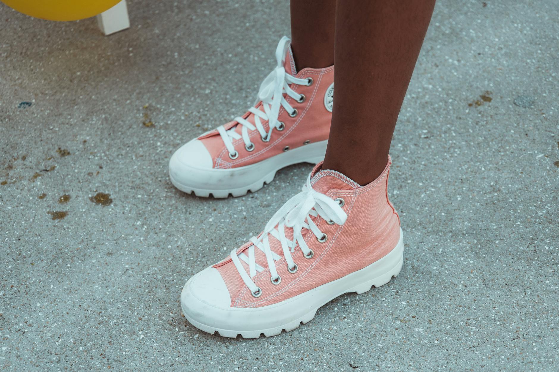 Close-up of glossy rubber footwear on a clean background, representing bold designer shoe design