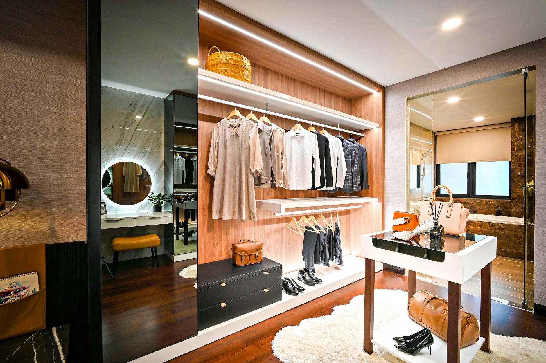 A curated wardrobe of neutral, structured luxury garments hung in a minimal space