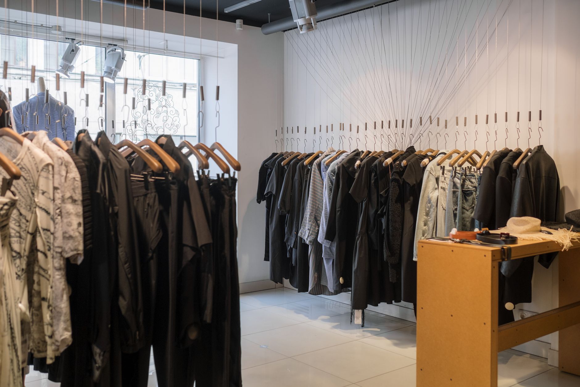 Interior of a contemporary fashion boutique displaying structured garments on racks