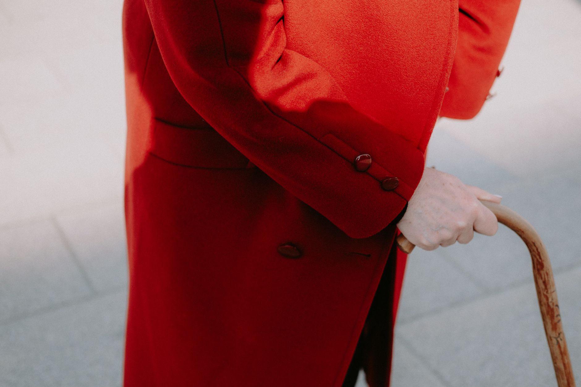 A model wearing a fitted, structured winter coat in a neutral tone, styled for a professional setting