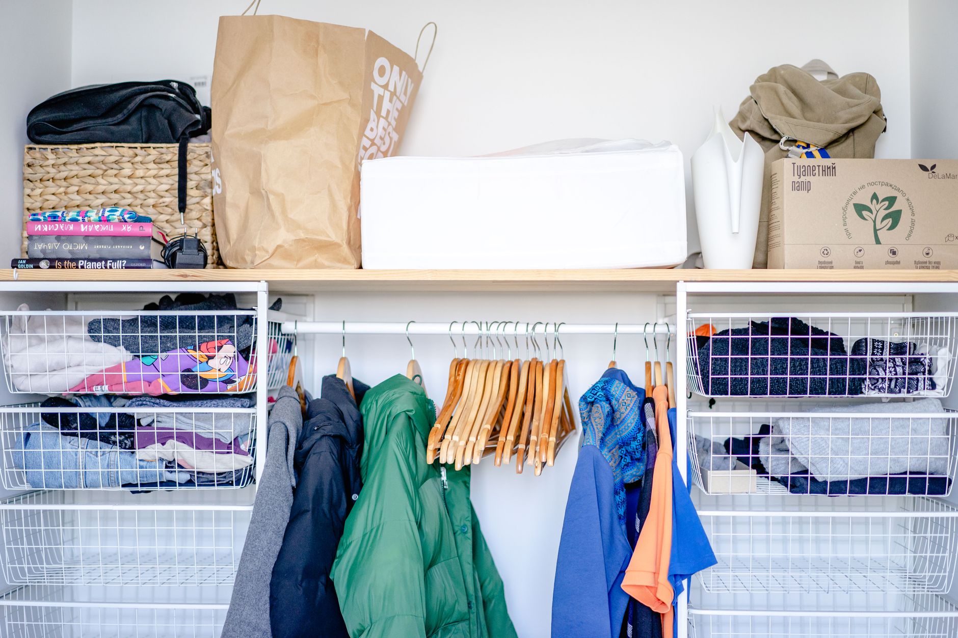 A neatly organized minimalist wardrobe with simple, solid-color garments