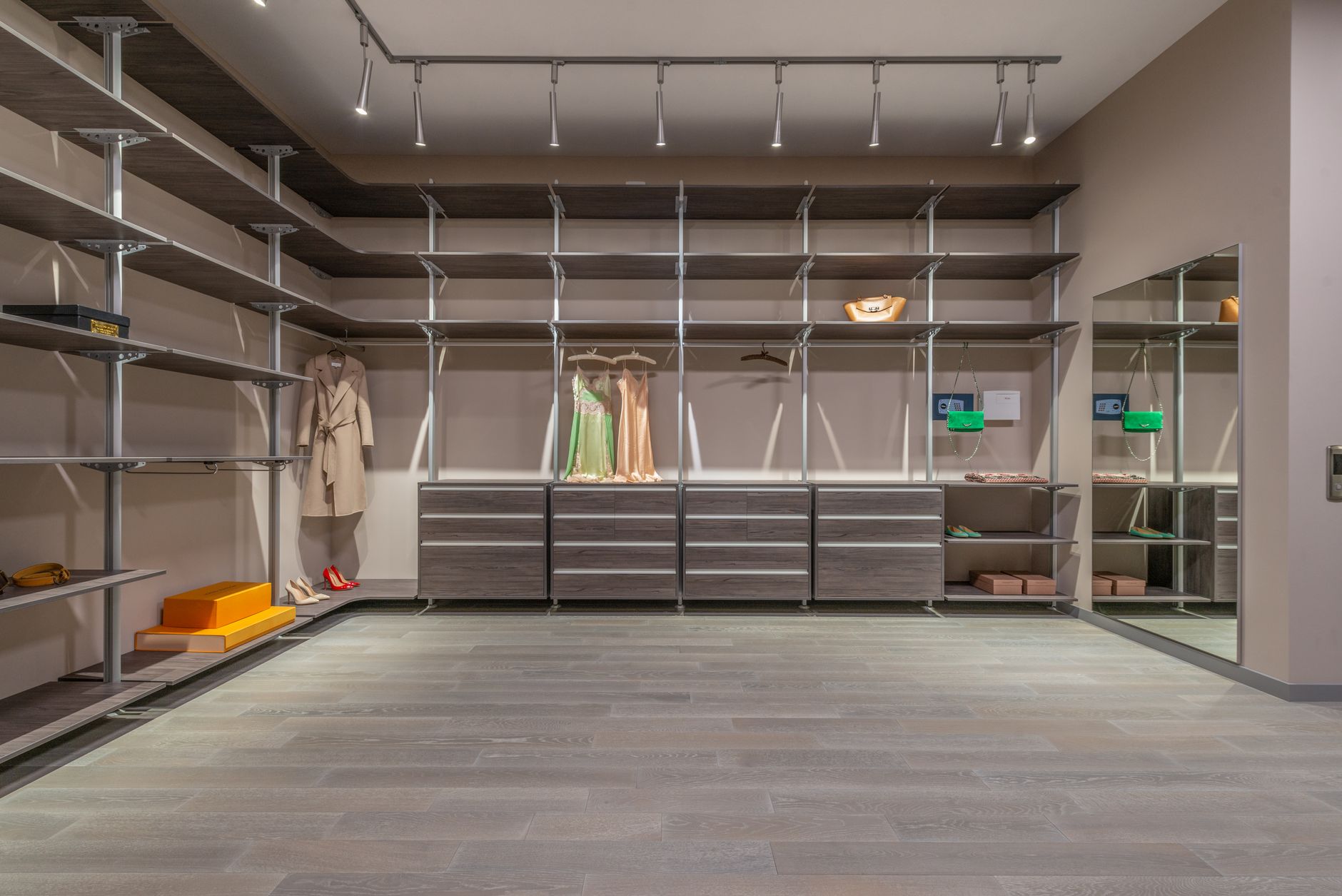 A carefully organized wardrobe featuring neutral-toned, high-end garments