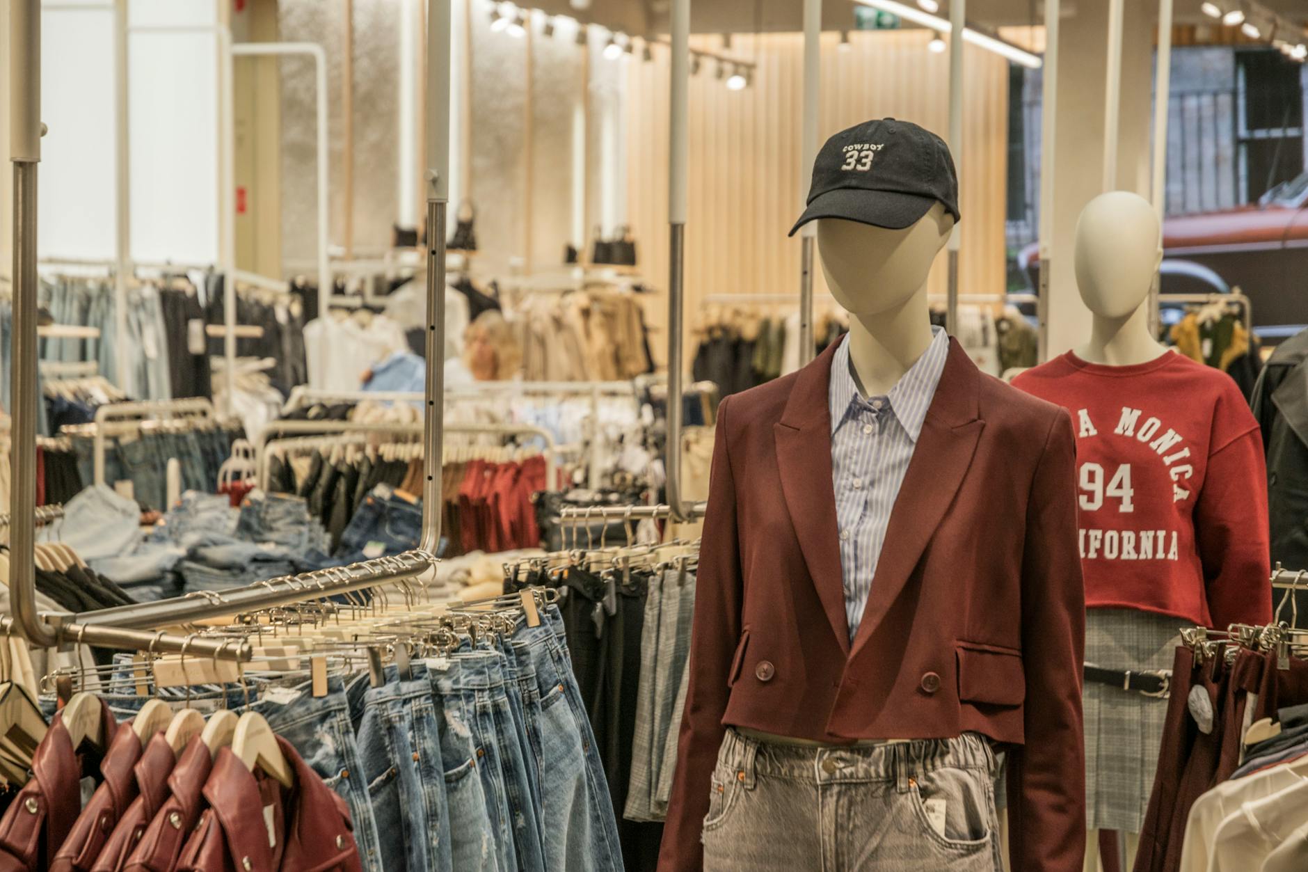 Minimalist luxury fashion boutique interior with designer accessories on display
