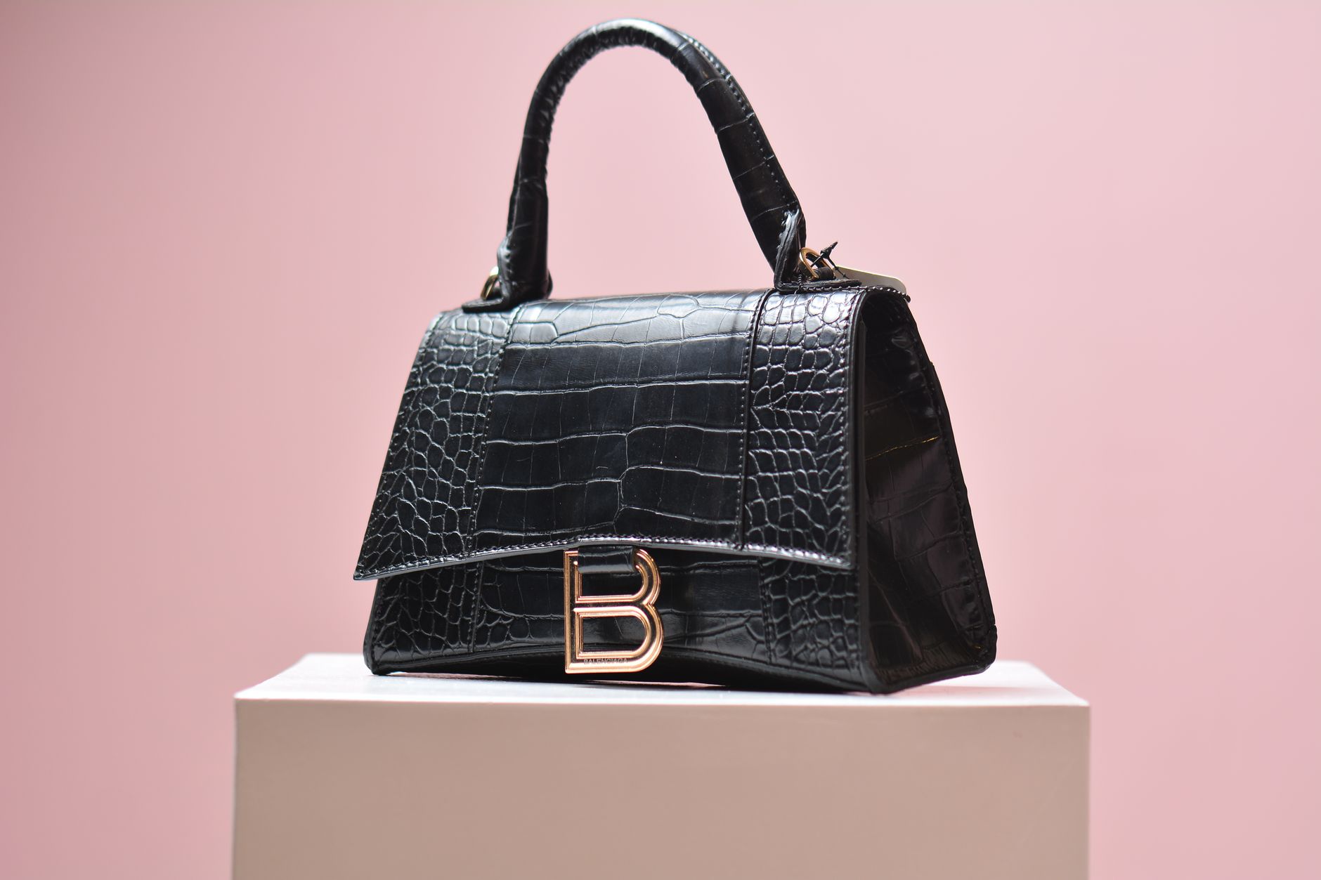 High-end leather handbags displayed in a minimalist retail environment