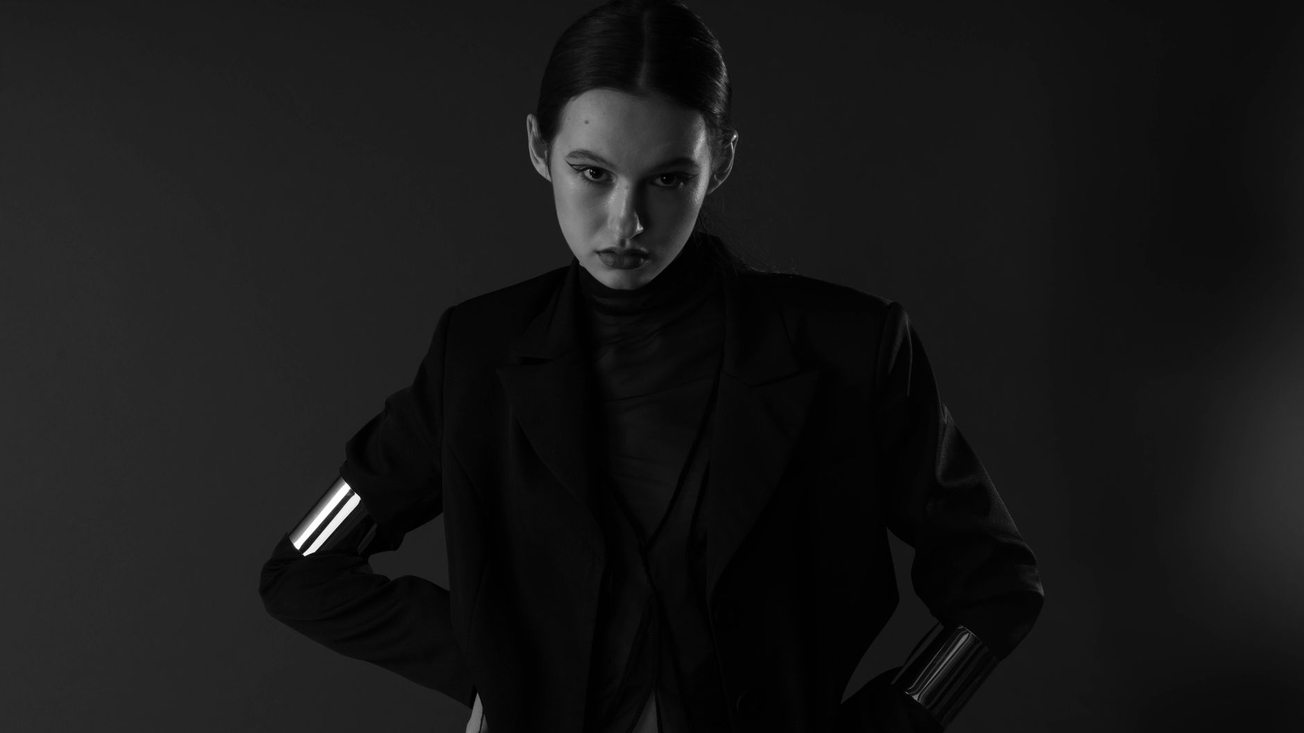Dramatic fashion runway look with dark Victorian-inspired silhouette and architectural construction