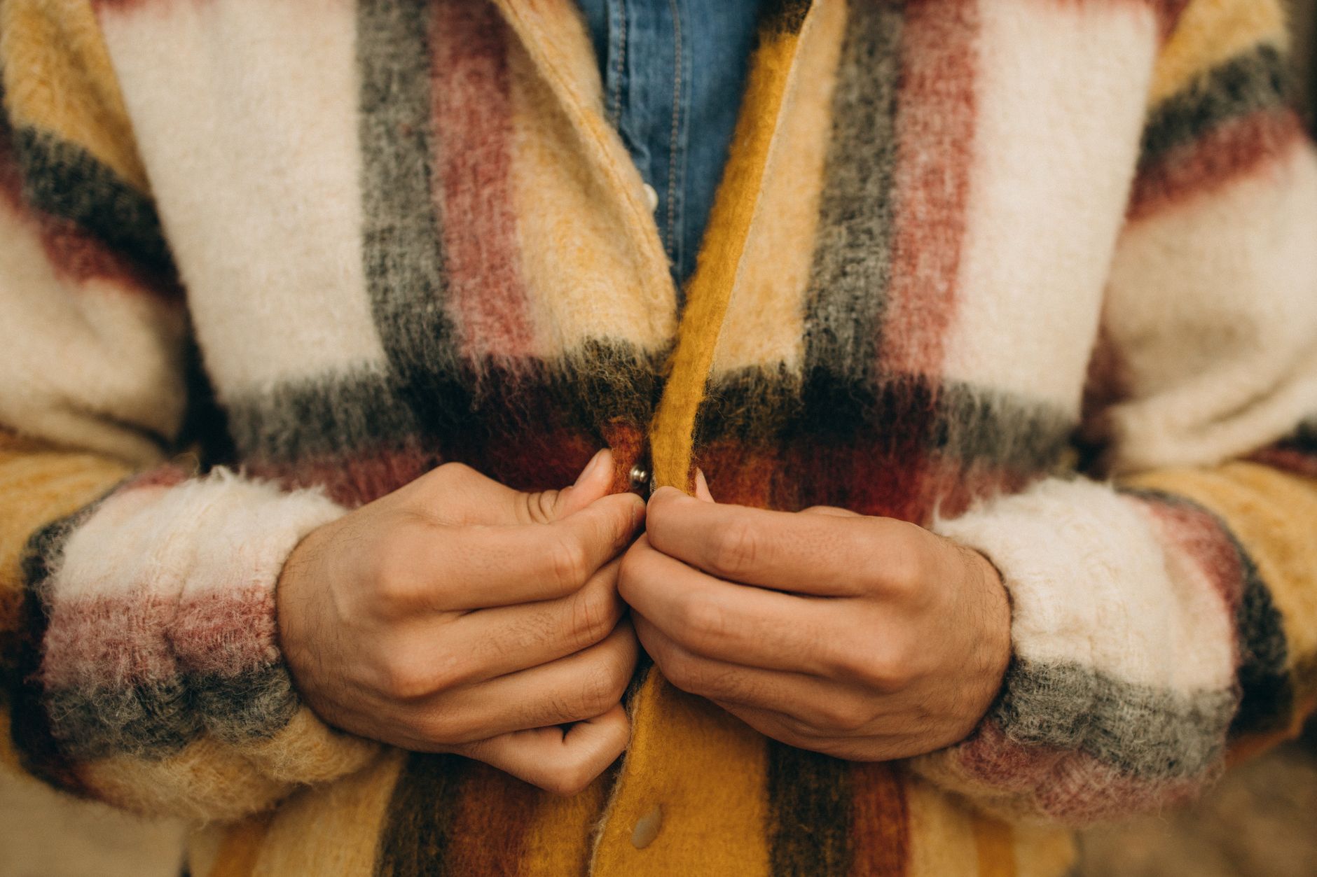 Close-up of fine wool fabric texture on a luxury outerwear piece